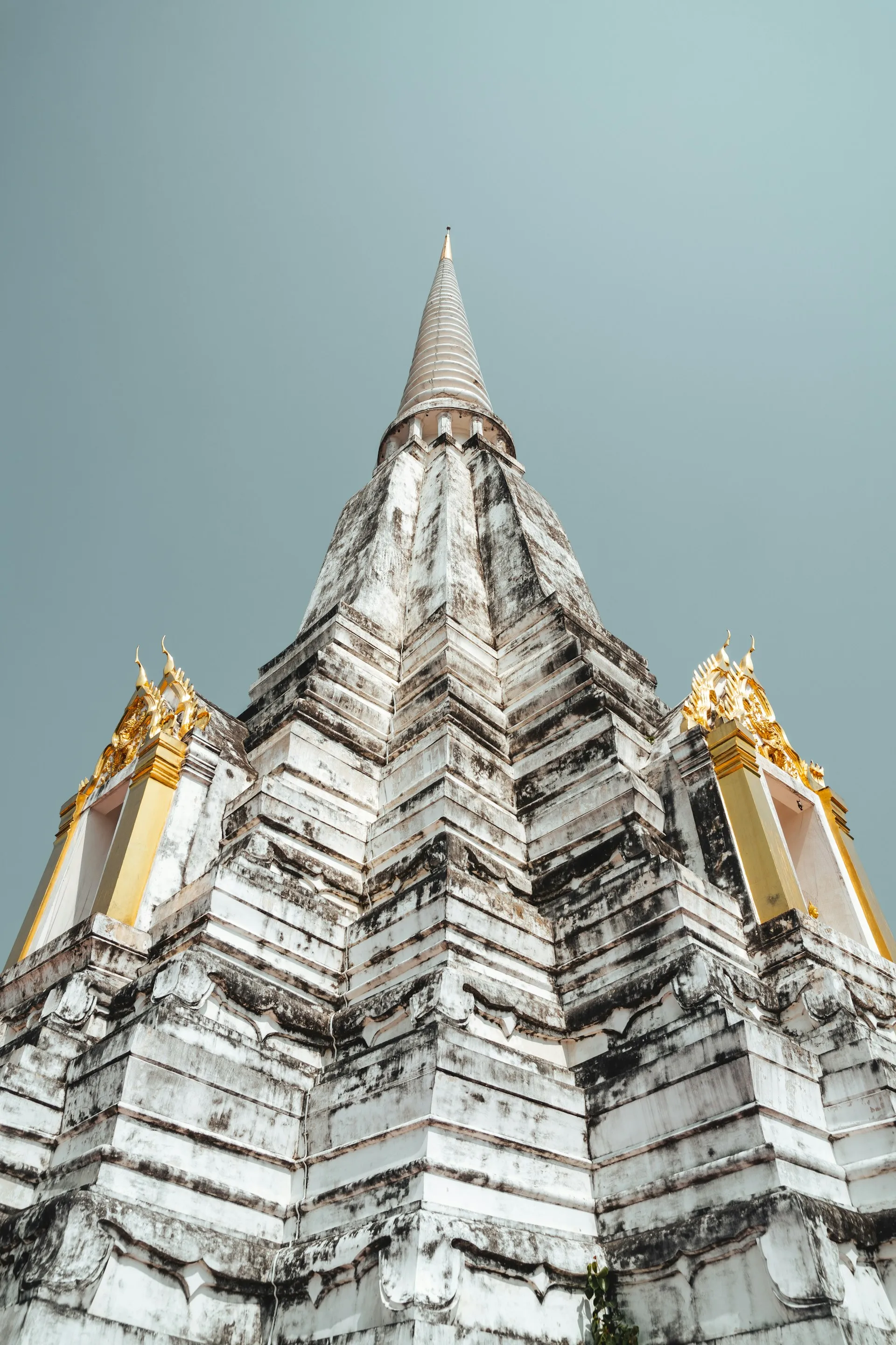 A weathered temple spire rising into a clear open sky